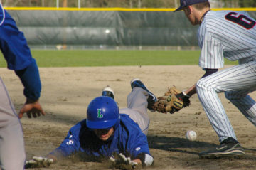 Runner diving into third base